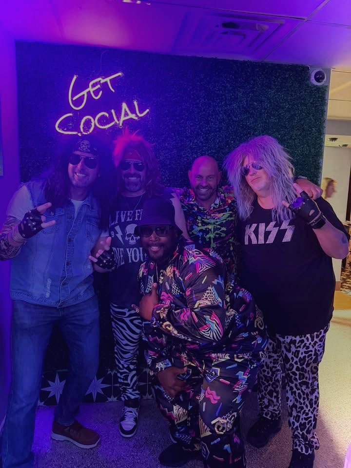 Downtown Social group photo under neon lighting